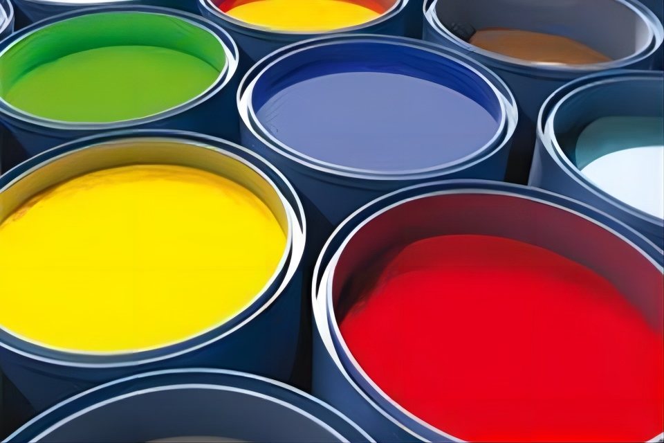 Open drums of coloured printing ink