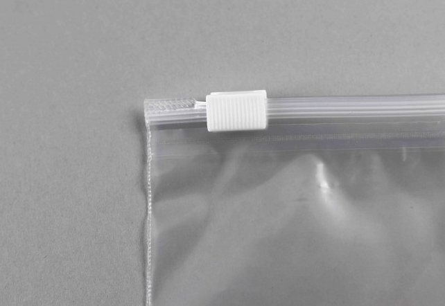 Corner of a clear bag with a white slider clip